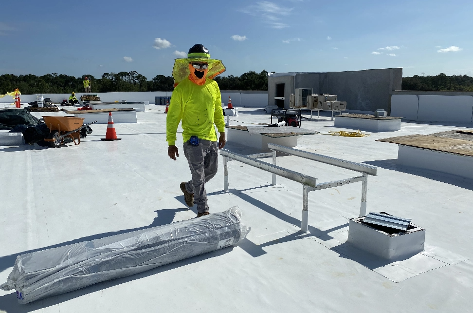 A contractor on a flat roof showcasing Universal Contracting and Solar's flat roof repairs service in Fort Myers